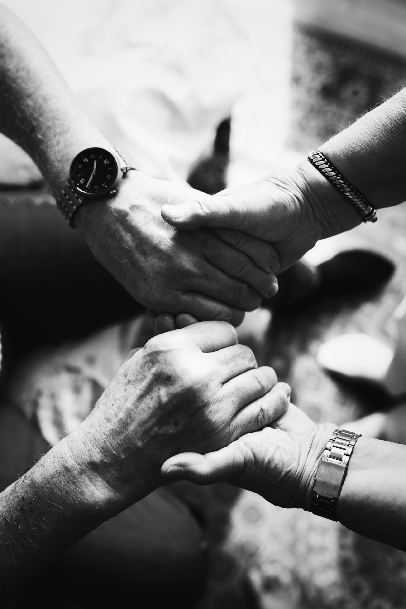 senior couple holding hands together
