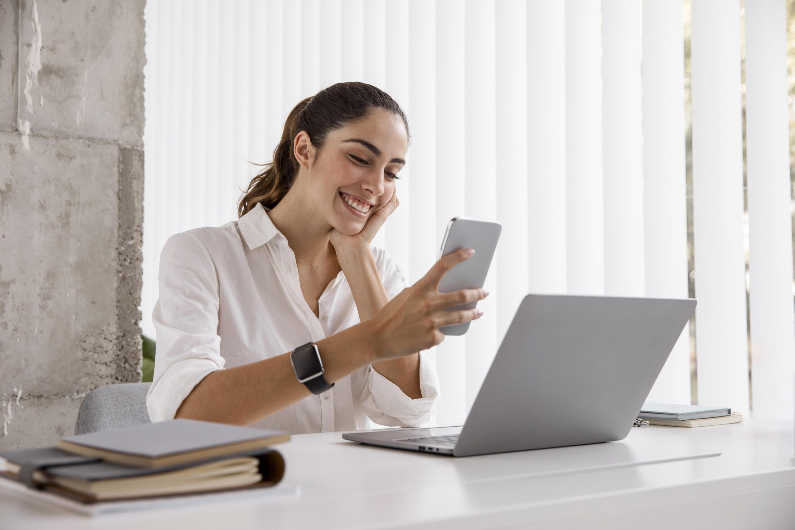 side view smiley businesswoman with smartphone laptop