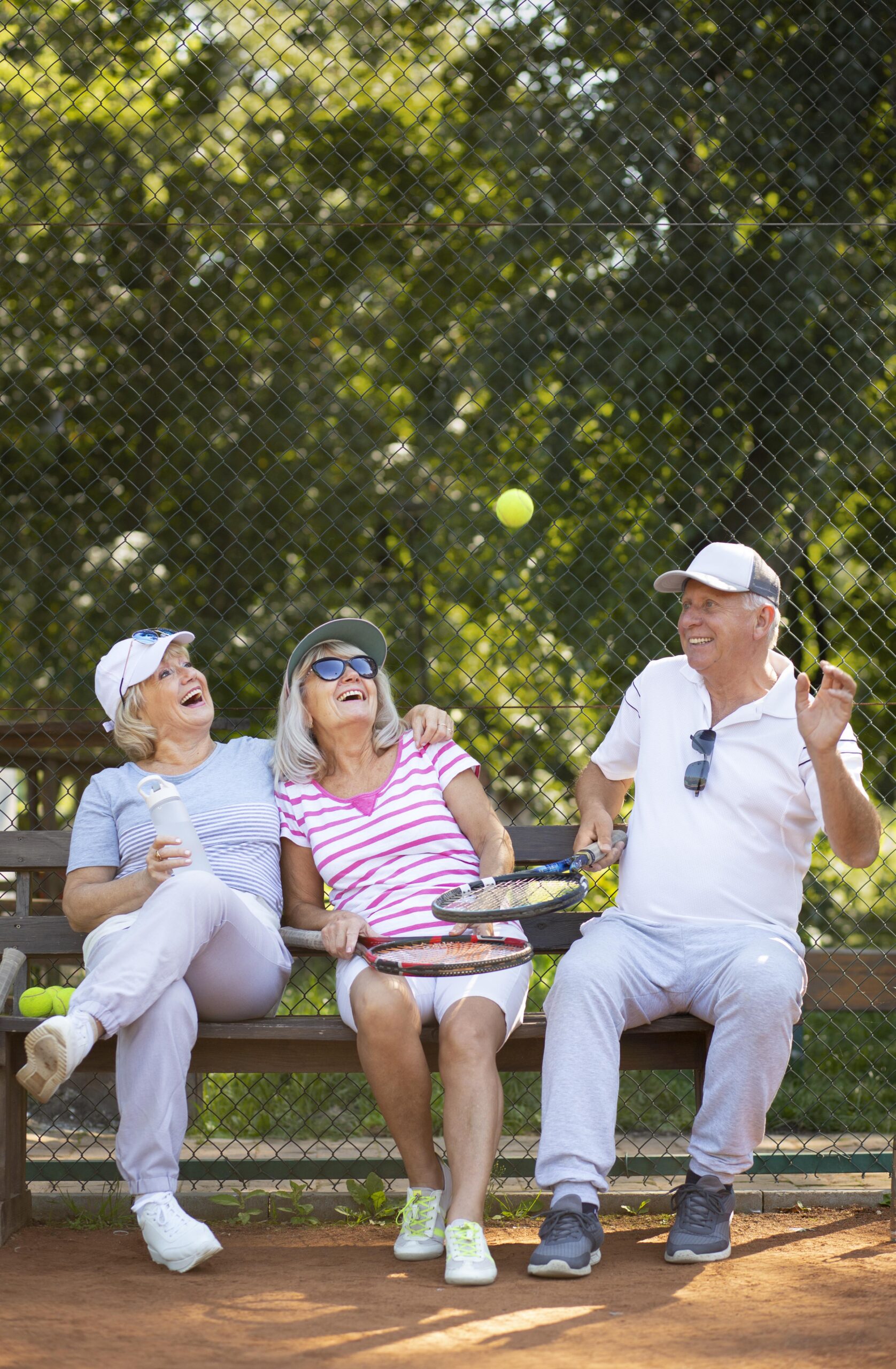 full shot happy friends sitting bench