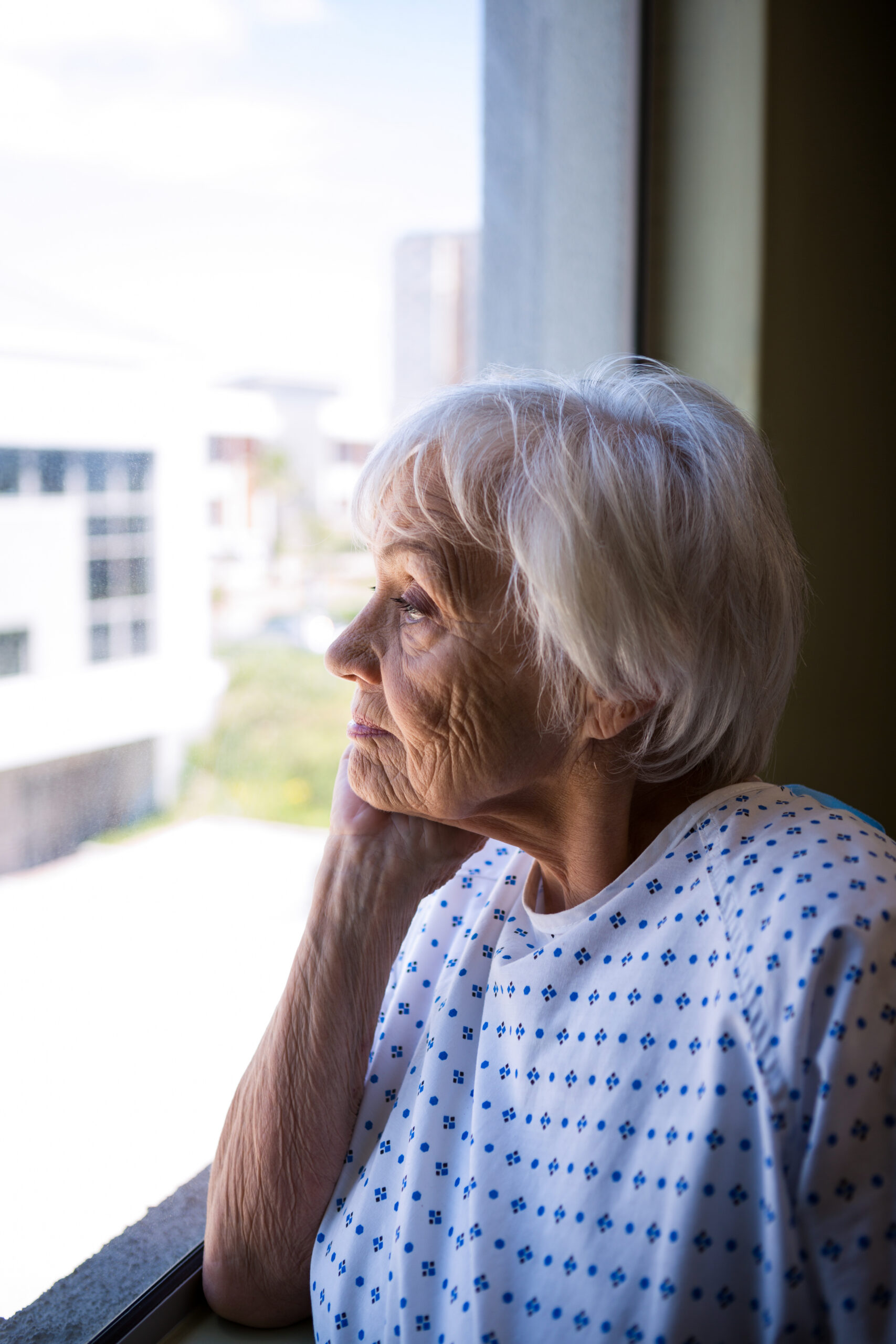 thoughtful senior woman looking out hospital windo 2026 03 26 11 50 44 utc