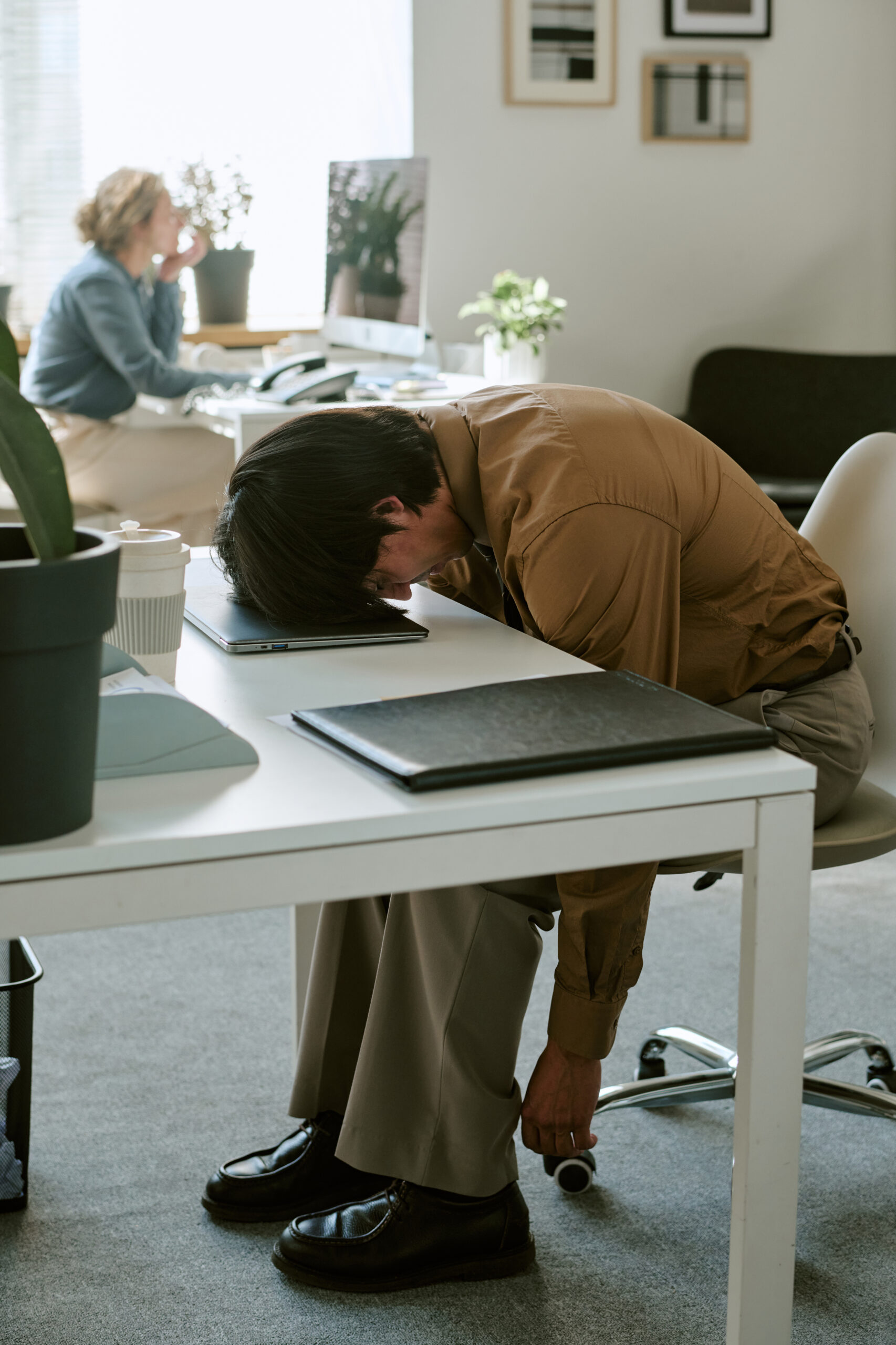 exhausted man resting head on laptop at office des 2026 09 28 16 37 17 utc